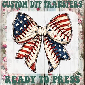 May include: A patriotic bow design with the American flag and baseball stitching. The bow has red and white stripes, blue stars, and red stitching. The text "CUSTOM DTF TRANSFERS" and "READY TO PRESS" are displayed in green.