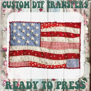 May include: A fabric American flag design with red and white stripes, a blue field with white stars, and a red stitched border. The text "CUSTOM DTF TRANSFERS" and "READY TO PRESS" are at the top and bottom.