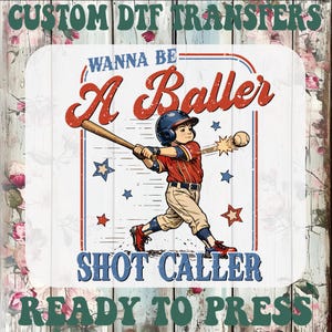 May include: A DTF transfer design featuring a baseball player swinging a bat. The design includes the text "Wanna Be A Baller Shot Caller" and "Ready To Press". The image has a vintage style with red, white, and blue accents.