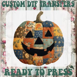 May include: A pumpkin-shaped graphic with a patchwork design featuring various floral and textured patterns in shades of orange, blue, and yellow. It has a black jack-o'-lantern face. The text reads CUSTOM DTF TRANSFERS READY TO PRESS.