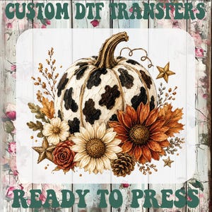 May include: A graphic design featuring a pumpkin with a black and white cow print pattern, surrounded by sunflowers, autumn leaves, a pinecone, and gold stars. The text CUSTOM DTF TRANSFERS READY TO PRESS is displayed in dark green at the top and bottom.