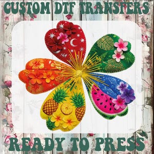 May include: A five-petaled flower graphic with yellow, orange, red, green, and blue sections featuring pineapple, watermelon, and celestial patterns, accented with small 3D-style flowers and yellow stamens. Text reads CUSTOM DTF TRANSFERS READY TO PRESS.