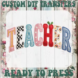 May include: A colorful DTF transfer design with the word "TEACHER" in various patterns and colors, including checkered, striped, polka dot, and rainbow designs. The text "CUSTOM DTF TRANSFERS" and "READY TO PRESS" are at the top and bottom.
