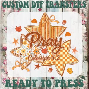 May include: A custom DTF transfer sheet featuring three stars with autumn-themed patterns, including stripes, floral prints, and orange checkers. The text reads "Pray" and "Colossian 4:2" in brown, surrounded by small leaves and acorns.