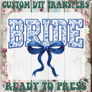 May include: A white background features the word "BRIDE" in blue floral print letters, with a blue bow beneath. The text "CUSTOM DTF TRANSFERS" and "READY TO PRESS" are at the top and bottom in green.