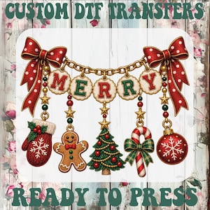 May include: A decorative graphic featuring the text CUSTOM DTF TRANSFERS and READY TO PRESS. The central design shows a gold chain with red polka-dot bows, hanging ornaments including a mitten, gingerbread man, tree, candy cane, and bauble.