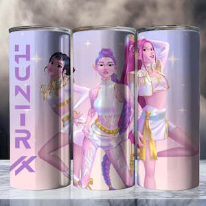 May include: Three stainless steel tumblers with a fantasy art design. Each tumbler features a different illustration of a woman in white and gold attire, with long hair. The word "J-U-N-I-K" is printed vertically on one tumbler.