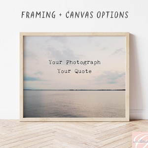 May include: A framed print featuring a landscape of a calm body of water under a cloudy sky. The text "FRAMING + CANVAS OPTIONS" appears above the frame, and the text "Your Photograph Your Quote" is centered on the image.