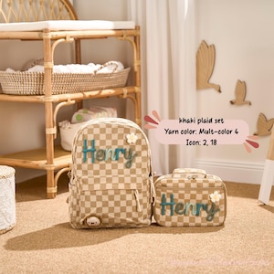 May include: Khaki plaid backpack and matching lunch bag set. Both items feature the name "Henry" in teal script and a small white flower accent. The backpack has a small bear detail. The set is part of the "khaki plaid set" collection.