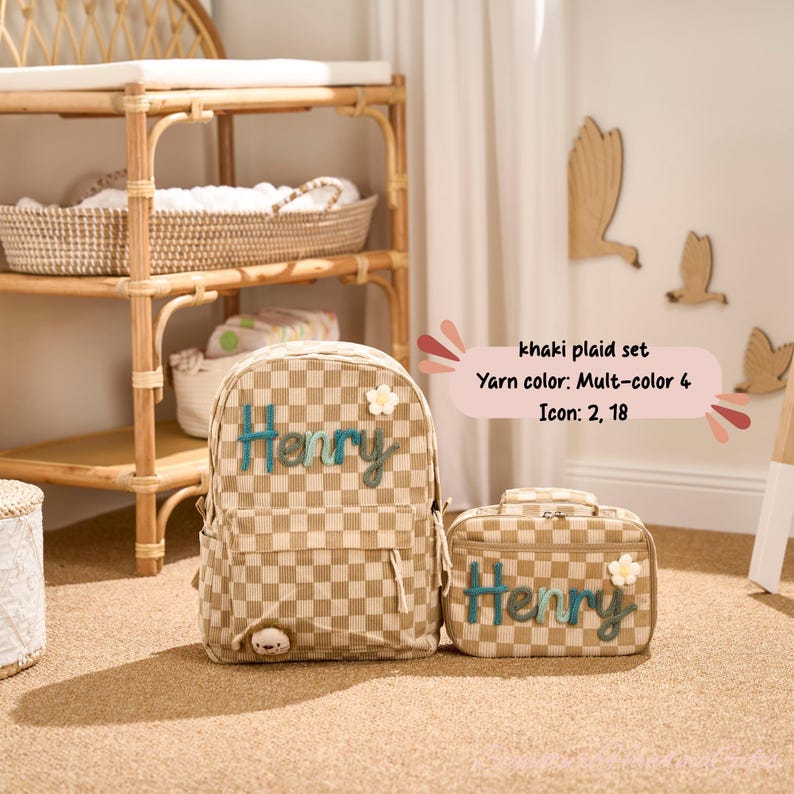 May include: Khaki plaid backpack and matching lunch bag set. Both items feature the name "Henry" in teal script and a small white flower accent. The backpack has a small bear detail. The set is part of the "khaki plaid set" collection.