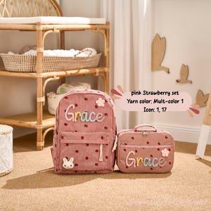 May include: A pink corduroy backpack and matching lunch bag set. The backpack and lunch bag are decorated with a strawberry pattern, the name "Grace", and a flower. The backpack has a front pocket and a small bunny detail.