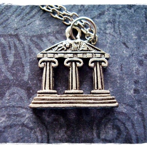 May include: Silver pendant necklace featuring a detailed miniature replica of a Greek temple with three columns.