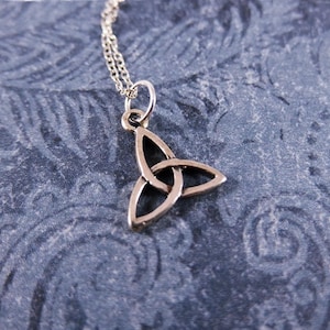 May include: A silver Celtic knot pendant necklace. The pendant is in the shape of a trinity knot, a traditional symbol of love, faith, and hope.