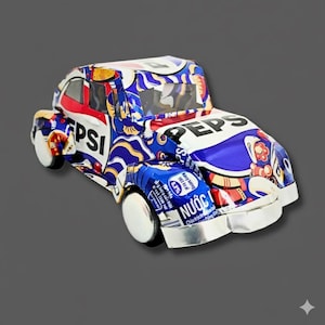 May include: A handcrafted toy car made from recycled Pepsi cans. The car features the Pepsi logo in white and blue, with red accents. The wheels are silver, and the car has a unique, artistic design.