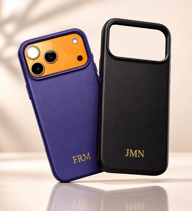 May include: Two phone cases: one purple with an orange camera area, and one black. Both cases have gold lettering. The purple case has "FRM" and the black case has "JMN".