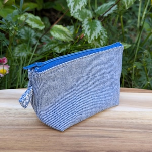 Eco-friendly upcycled denim coin purse. Handmade zipped pouch from recycled jeans - unique gift.