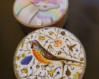 May include: Two rolls of washi tape. One roll features a rainbow unicorn with the text "Rainbow Unicorn". The other roll features a colorful bird with a floral pattern.