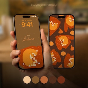 Könnte beinhalten: Zwei Smartphones mit herbstlichen digitalen Hintergrundbildern, die orangefarbene Katzen auf Pullovern und Kürbissen zeigen. Der linke Bildschirm zeigt die Uhrzeit 9:41 und den Text "Hello Autumn" auf braunem Grund mit einer schlafenden Katze.