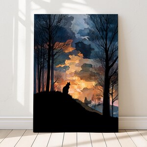 May include: A framed art print featuring a silhouette of a cat perched on a hill, set against a watercolor sunset. The artwork showcases a dark, moody forest with bare trees and a vibrant sky of orange, yellow, and blue hues.