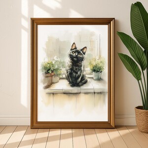 May include: A framed watercolor painting of a black cat sitting on a windowsill, looking up. The cat is surrounded by potted plants. The frame is gold, and the background is a soft, blurred view of the outdoors.