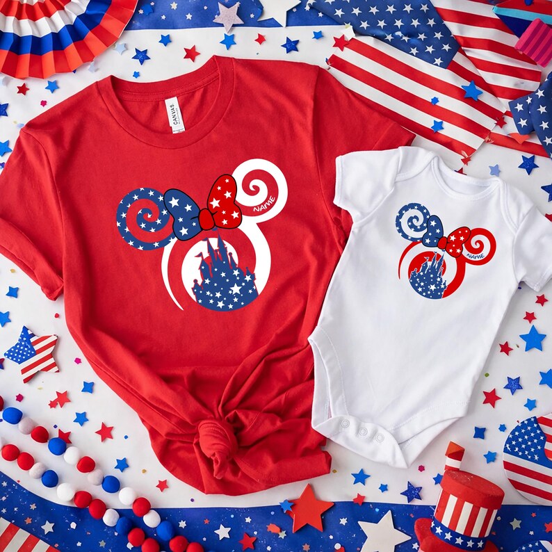 May include: Red t-shirt and white onesie featuring a patriotic Minnie Mouse design. The design includes a bow, ears, and a castle silhouette filled with stars. The word "Name" is printed on the design.