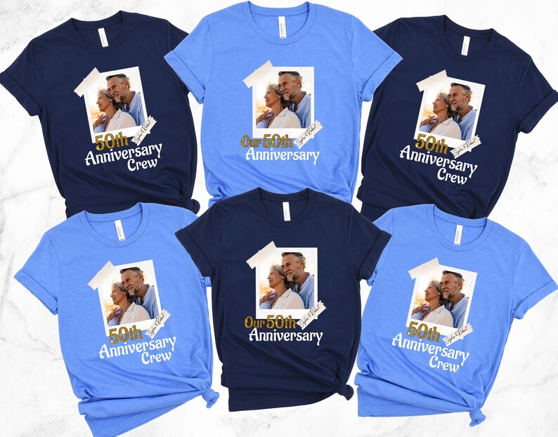 May include: A collection of short-sleeved t-shirts in various shades of blue. Each shirt features a printed image of a couple and the text "50th Anniversary Crew" or "Our 50th Anniversary". The shirts are likely for an anniversary celebration.