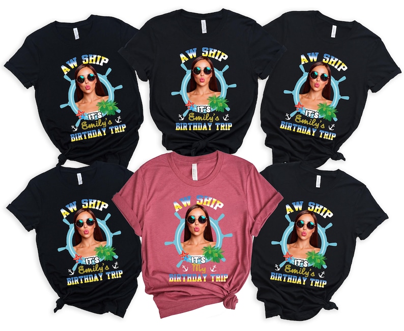 May include: A collection of black and maroon t-shirts featuring a graphic of a woman wearing sunglasses inside a ship's wheel. The text on the shirts reads "AW SHIP" and "It's Emily's Birthday Trip."