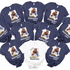 May include: A collection of navy blue and white t-shirts. Each shirt features a printed photograph of a couple and the text "50th Anniversary Crew". The white shirt has the text "Our 50th Anniversary".