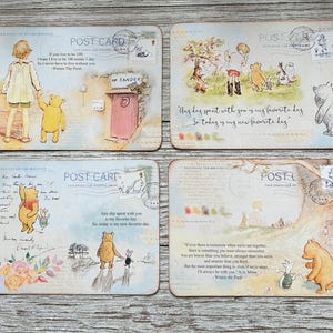 May include: Set of four Winnie the Pooh themed postcards with vintage-inspired illustrations and quotes. The postcards feature Winnie the Pooh and Piglet in various scenes, including walking in the woods, playing with a balloon, and sitting on a bench. Each postcard has a different quote from the Winnie the Pooh stories.