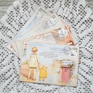May include: A set of four vintage-style postcards featuring a drawing of Winnie the Pooh and Piglet walking together. The postcards have a light blue background with a quote from Winnie the Pooh: "If you live to be 100, I hope I live to be 100 minus 1 day. So I never have to live without you." - Winnie the Pooh.