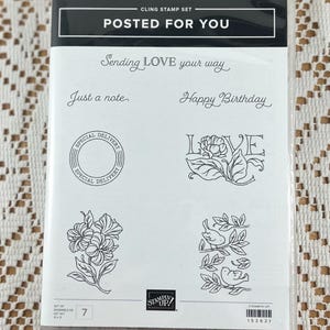 May include: A set of seven clear cling stamps with black ink designs. The stamps feature the words "Sending LOVE your way", "Just a note", "Happy Birthday", "LOVE", and "SPECIAL DELIVERY". The stamps also feature a floral design and a design of two birds on a branch.