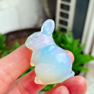 May include: A white ceramic mug with a black handle and the text "But First, Coffee" in a bold, black font. The mug is set against a neutral background, highlighting its simple design.