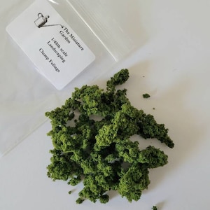 May include: A bag of green clump foliage for 1/48th scale model landscaping. The bag has a label that reads "The Miniature Garden 1/48th scale Landscaping Clump Foliage".