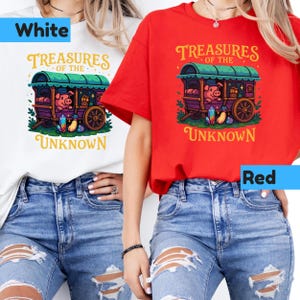 May include: White and red t-shirts with a graphic featuring a pig in a wagon with the text "Treasures of the Unknown". The design includes a green roof, purple wagon, and colorful gems. The shirts are paired with blue jeans.