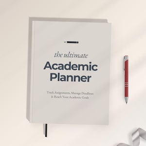 May include: A light gray academic planner with a black pencil icon and the text "the ultimate Academic Planner" followed by "Track Assignments, Manage Deadlines & Reach Your Academic Goals." A red pen is positioned to the right of the planner.