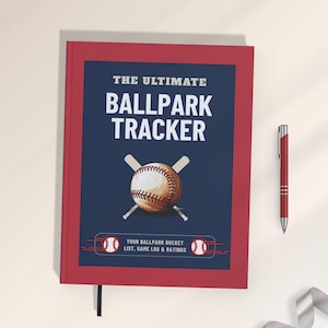 May include: A red hardcover journal titled The Ultimate Ballpark Tracker with a dark blue center panel featuring a baseball and two crossed bats. The text reads Your Ballpark Bucket List, Game Log & Ratings. A red pen is positioned to the right.