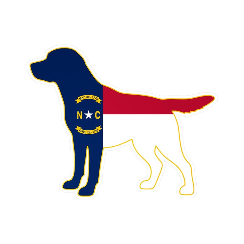 May include: A sticker in the shape of a dog, featuring the North Carolina state flag design. The dog's head and front are navy blue, with a gold emblem. The body is divided into red and white sections.