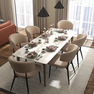 May include: A white marble dining table with six beige chairs. The table has a modern design with a sleek, minimalist look. The chairs are upholstered in a soft, neutral fabric.