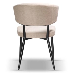 May include: A beige upholstered dining chair with a black metal frame and angled legs.