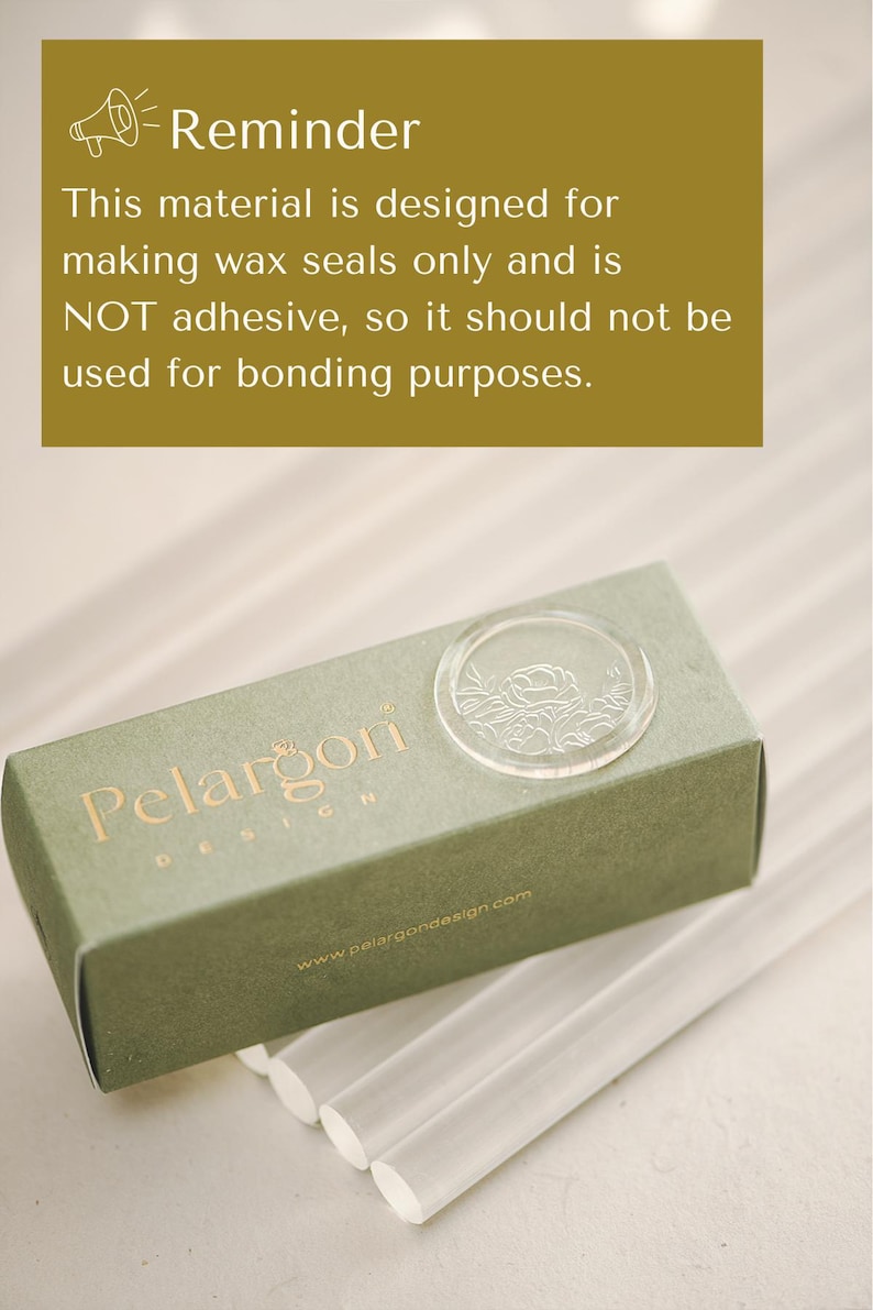 May include: A green box with the text "Pelargon Design" and a clear wax seal stamp. The box is sitting on a white surface with several clear wax sticks.