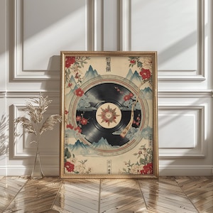 May include: A framed art print showcasing a black vinyl record design with a central starburst, set against a backdrop of mountains, clouds, and floral elements. The artwork is framed in a gold-coloured frame and includes Japanese text.