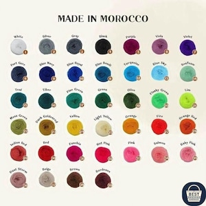 May include: A color chart of yarn balls, each labeled with a color name and number. Colors include white, silver, gray, black, purple, and violet. The text "MADE IN MOROCCO" is at the top.