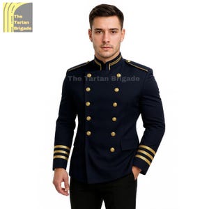 May include: Navy blue double-breasted jacket with gold buttons and trim. The jacket features gold stripes on the sleeves and the text "The Tartan Brigade". A formal, military-inspired garment.