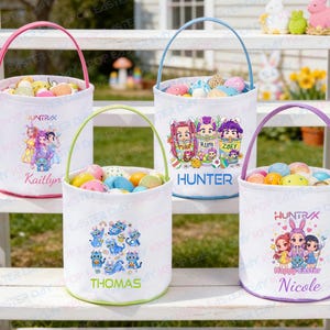May include: White Easter baskets with colorful handles and personalized names. Each basket is filled with Easter eggs and features a unique design, including cartoon characters and the text "Kaitlyn", "Hunter", "Thomas", and "Nicole".