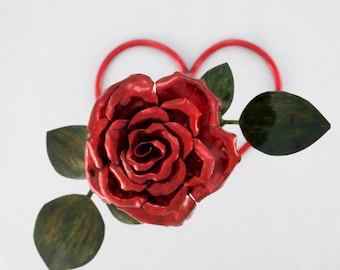 Rosa roja floreciente mediana con escultura de metal de cobre con base de corazón rojo