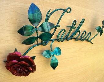 May include: Metal wall art featuring a stylized rose with a red bloom and green leaves. The word "Father" is incorporated into the design.
