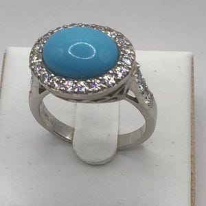 Oval turquoise solitaire with crystal surround sterling silver ring size Q