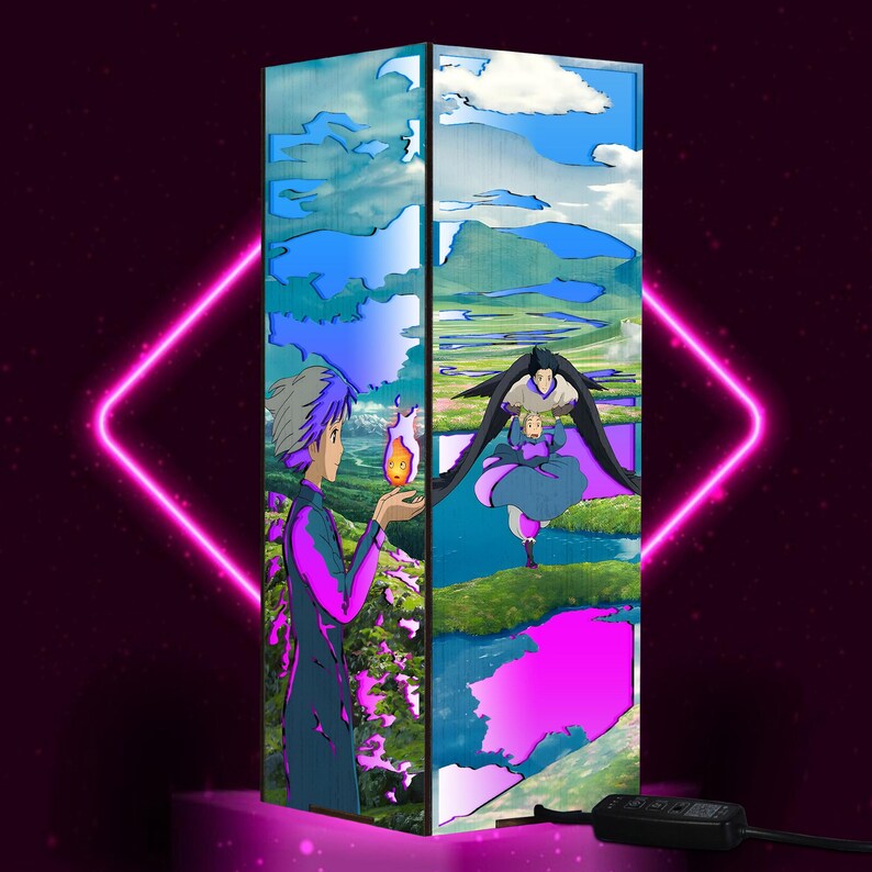 May include: A rectangular lamp featuring artwork from the animated film "Howl's Moving Castle." The lamp's design includes characters and landscapes from the movie, with a color palette of blue, purple, and green. The lamp has a black power cord.