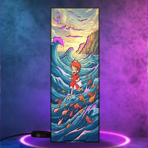 May include: A rectangular LED light panel featuring a colorful illustration of a small child with red hair running across blue ocean waves surrounded by orange fish, with a rocky cliffside in the background under a cloudy sky, connected by a black cord.