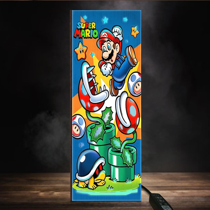 Puede incluir: Panel vertical con una ilustraci&oacute;n de Super Mario. La obra muestra a Mario saltando, junto con estrellas, champi&ntilde;ones y plantas Pira&ntilde;a, sobre un fondo azul y naranja. Las palabras "SUPER MARIO" est&aacute;n en la parte superior. El panel es rectangular.